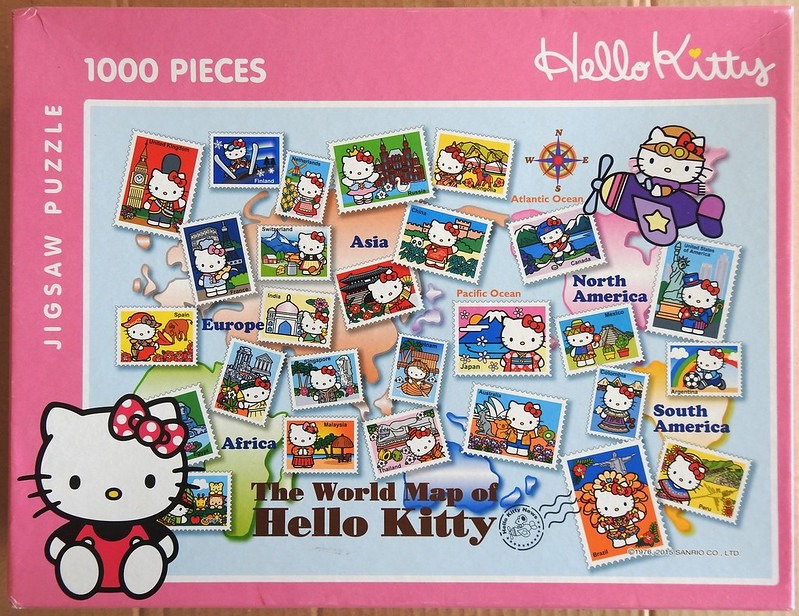 A whimsical world map illustrated with stamps of Hello Kitty characters in various countries and traditional outfits.