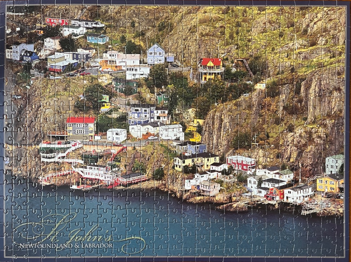 A coastal town with colorful houses nestled into the rocky cliffs of St. John's, Newfoundland.