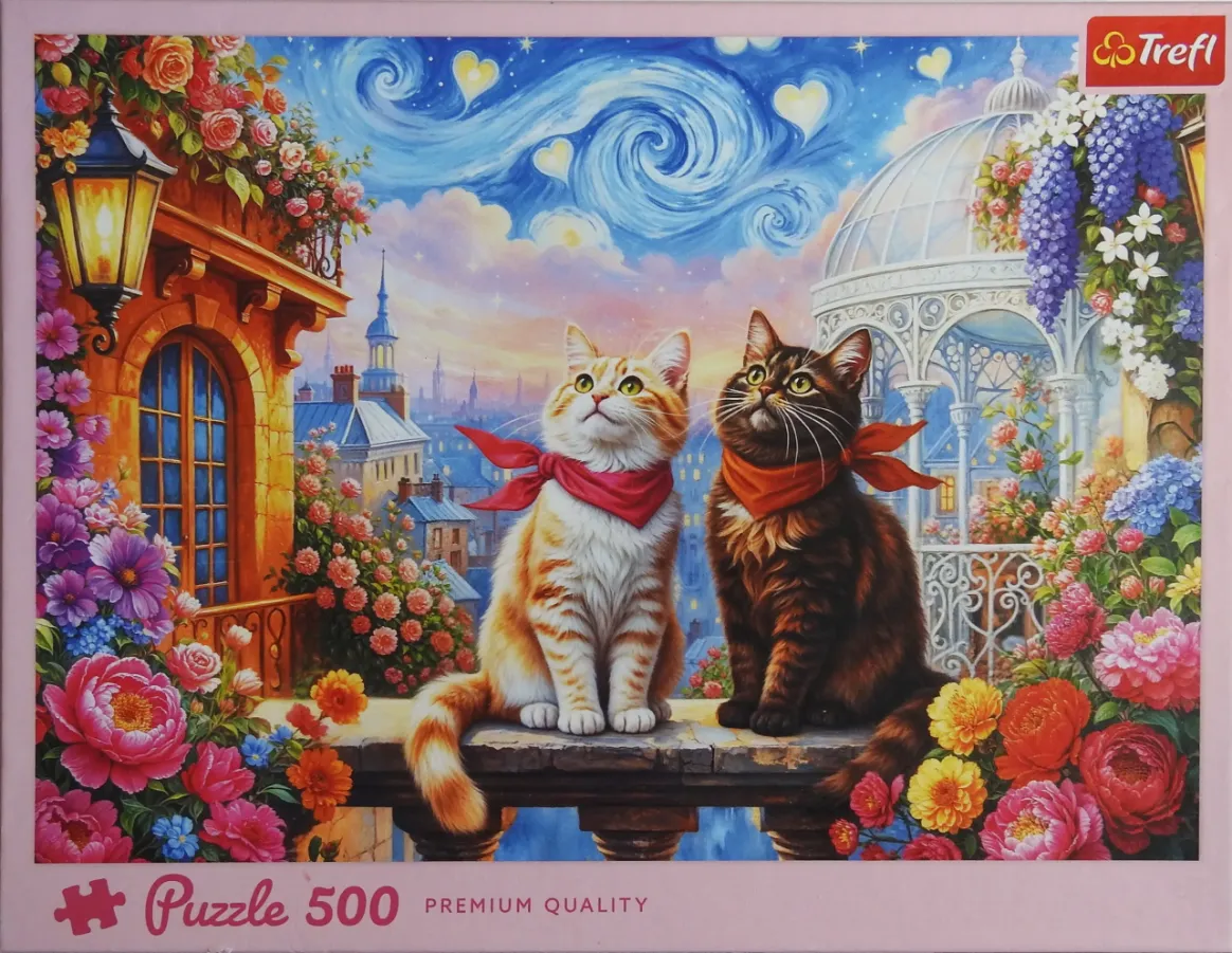 Two cats wearing red neckerchiefs sit on a stone balcony overlooking a whimsical, starry evening cityscape.