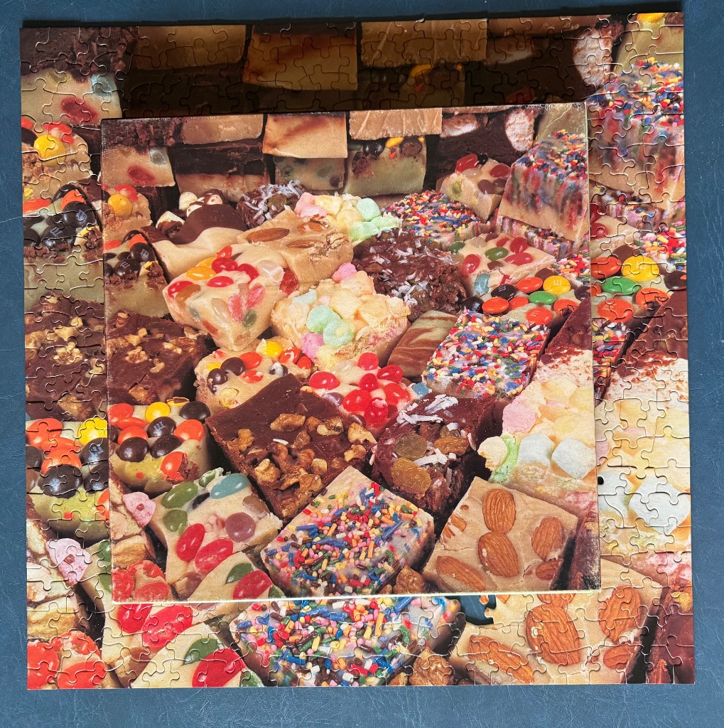 Assortment of colorful, decadent fudges and confections with nuts and sprinkles.
