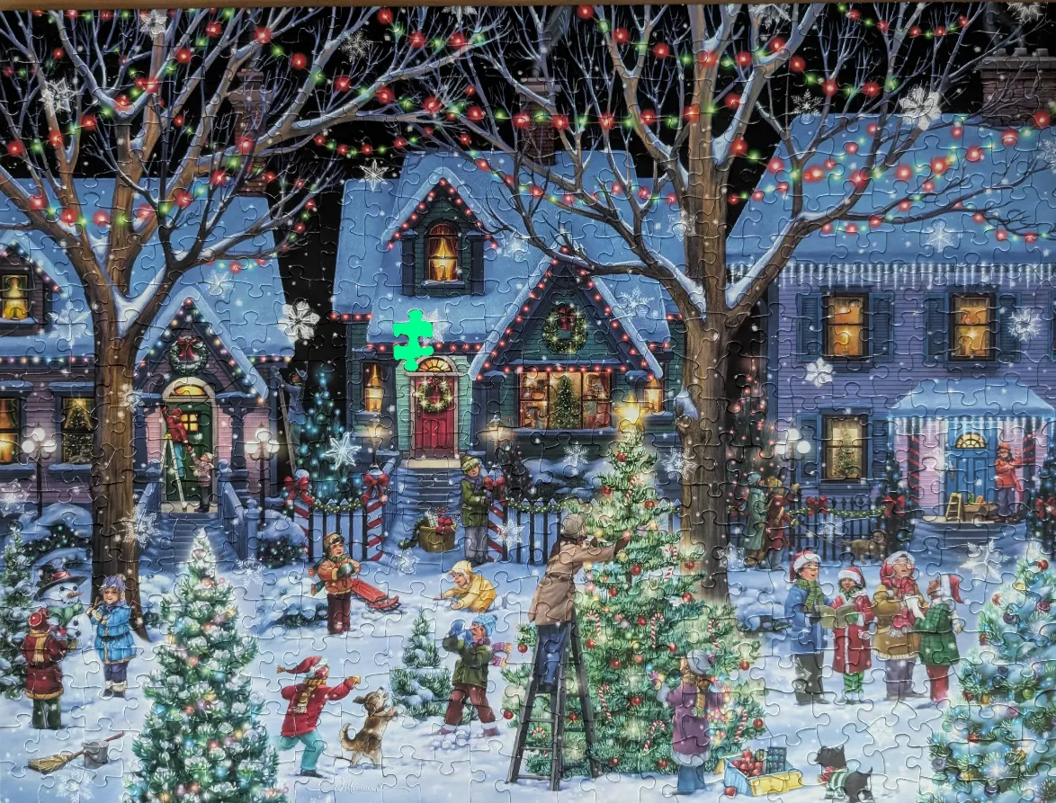 A snowy Christmas evening scene featuring decorated houses and children playing outside.