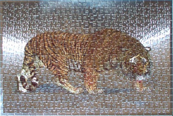 A majestic tiger with dark stripes and golden fur stands against a dark, metallic-textured background.