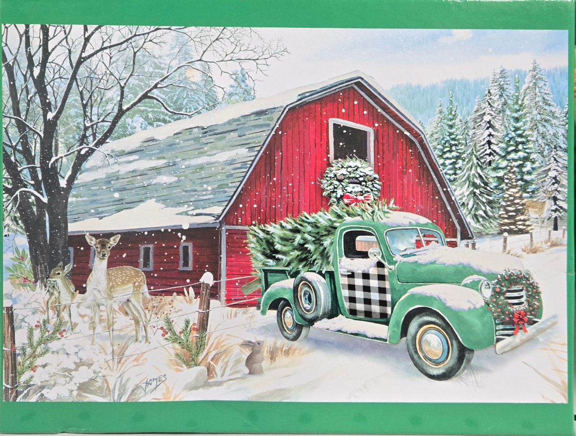 Vintage green truck hauling a Christmas tree in front of a red barn in a snowy winter scene with deer.