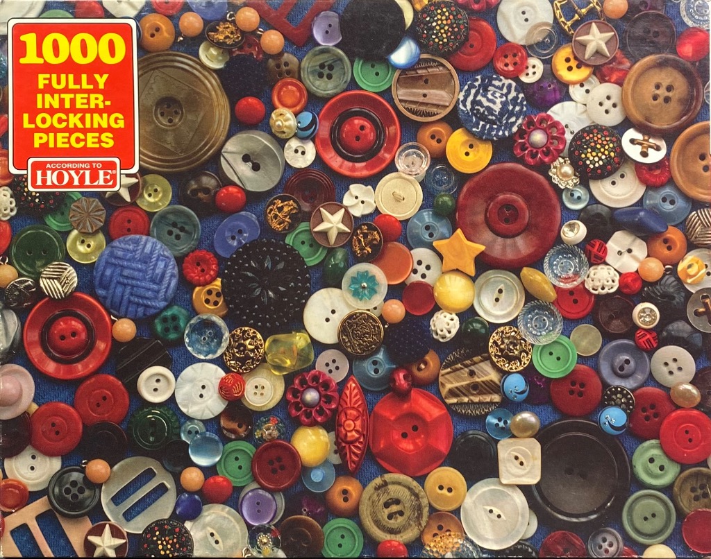 A dense, colorful collection of various sewing buttons scattered across a vibrant blue background.