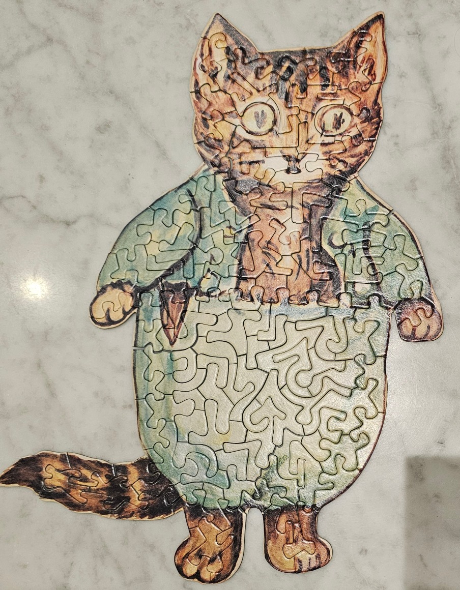 An illustration of a Tabby cat wearing a blue jacket and light-coloured trousers, designed as a silhouette.