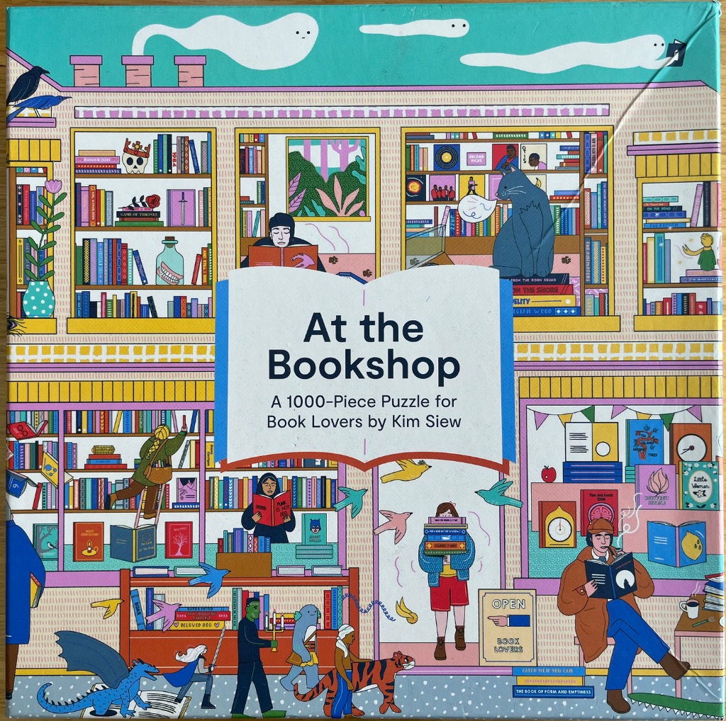An illustrated bookstore interior filled with diverse characters reading, shelves of books, and magical creatures.