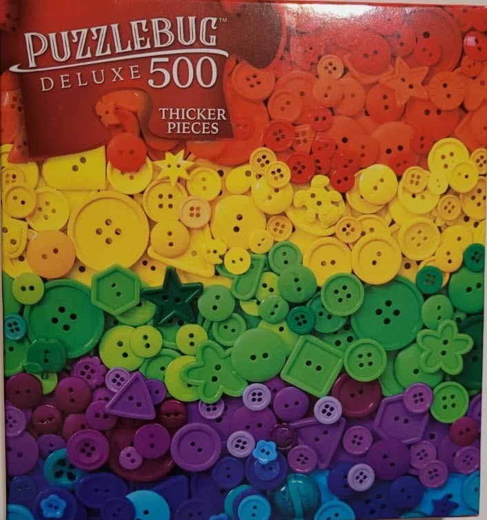 A dense, overhead collection of buttons in a rainbow gradient from red at the top to blue at the bottom.