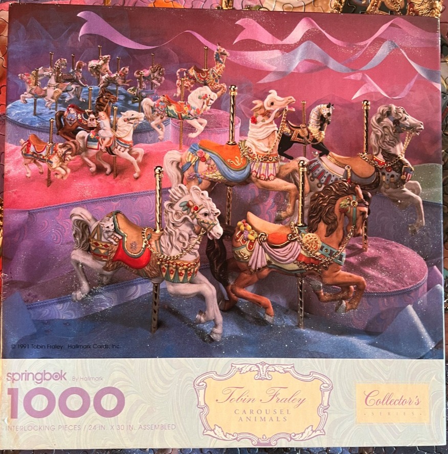 A collection of ornate, decorative carousel horses arranged on a multi-tiered platform against a soft, flowing background.