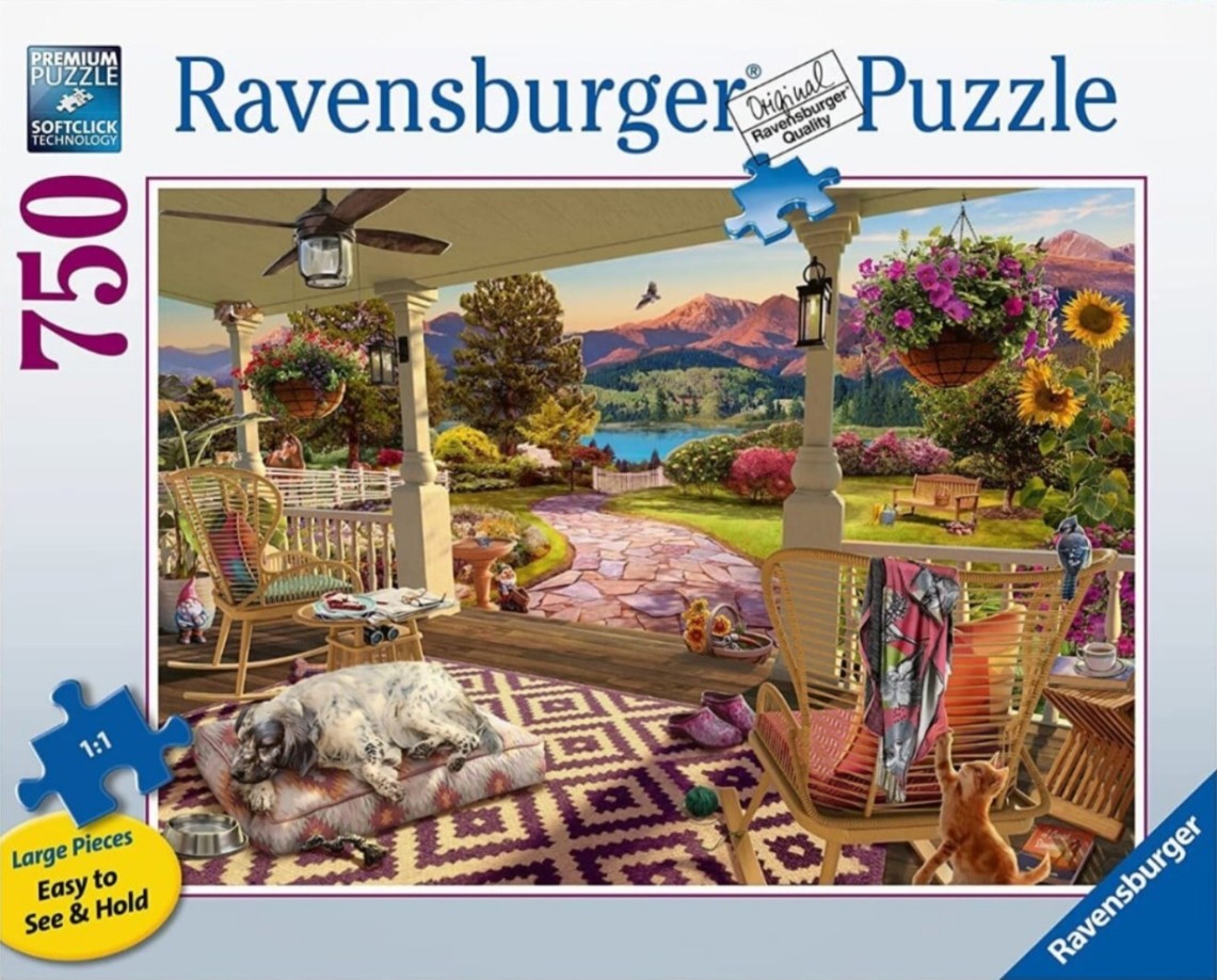 A peaceful porch scene featuring a sleeping dog, a kitten, and a stunning mountain lake view.
