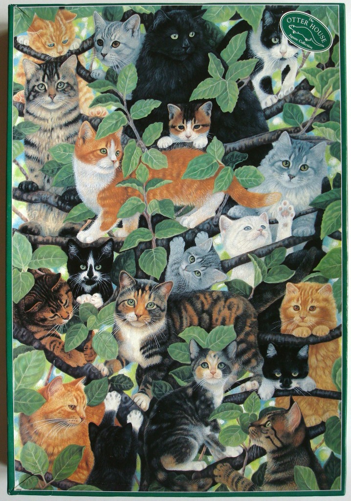 A group of many different domestic cats perched among the leafy branches of a tree.