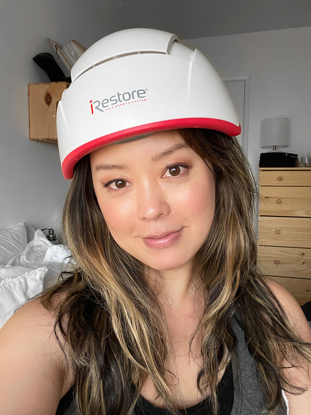 Serein Wu wearing the iRESTORE professional device. Her hair is at chest length.
