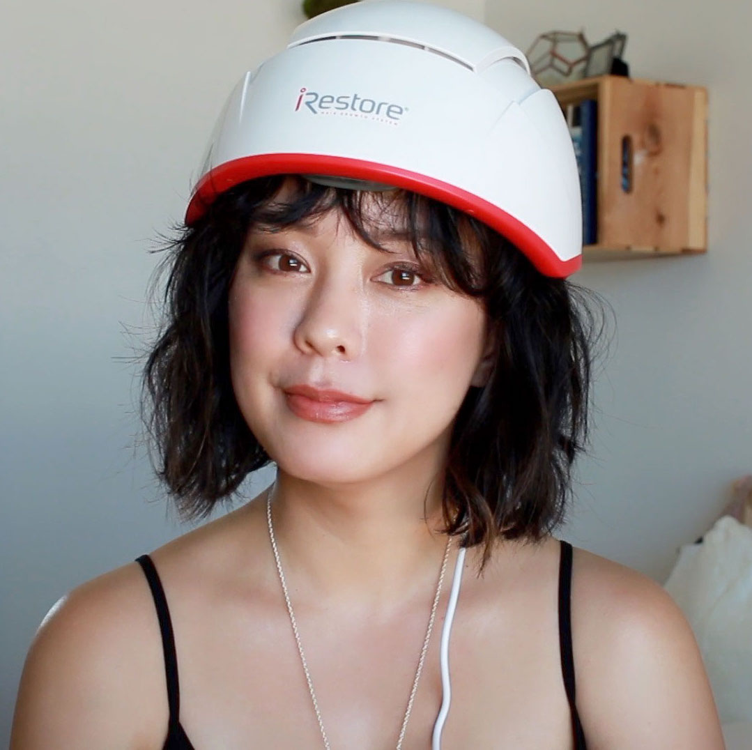 Serein Wu wearing the iRESTORE professional device. Her hair is at neck length.