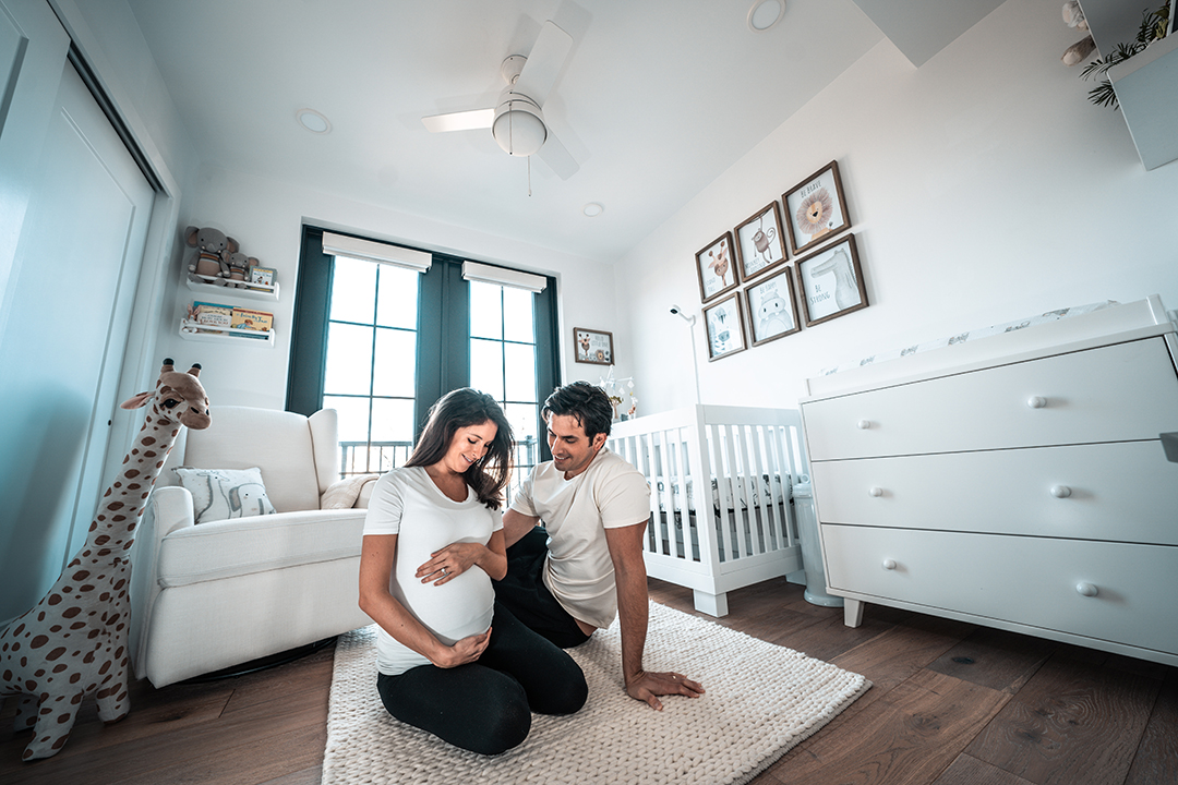 Pregnant woman and man sitting on the floor.