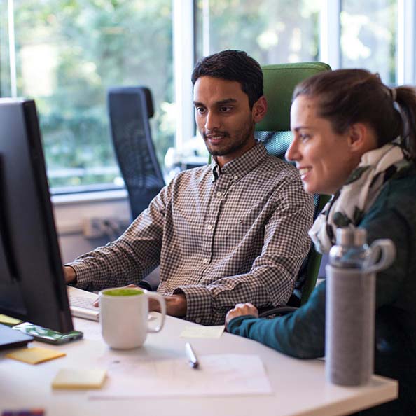 Two people looking at a monitor