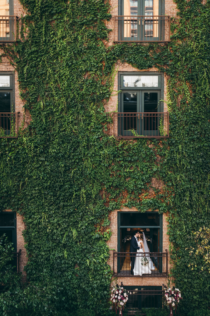 Couple in window with ivy wall