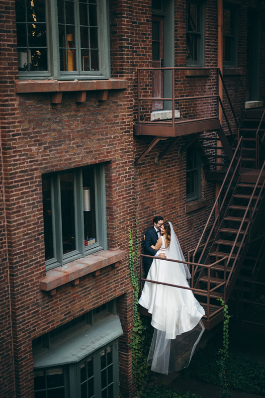 Couple on fire escape in courtyard