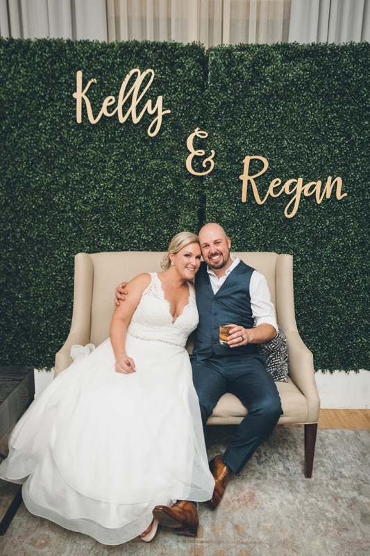 Couple in front of boxwood walls