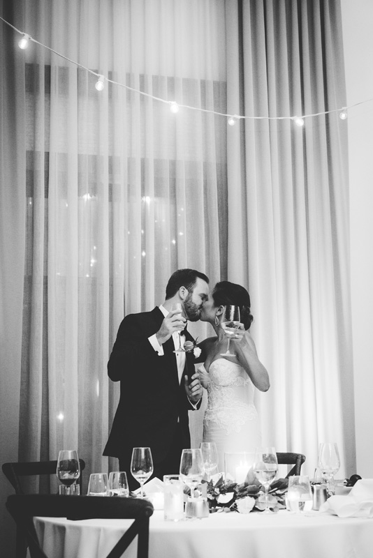 Couple kissing at sweetheart table