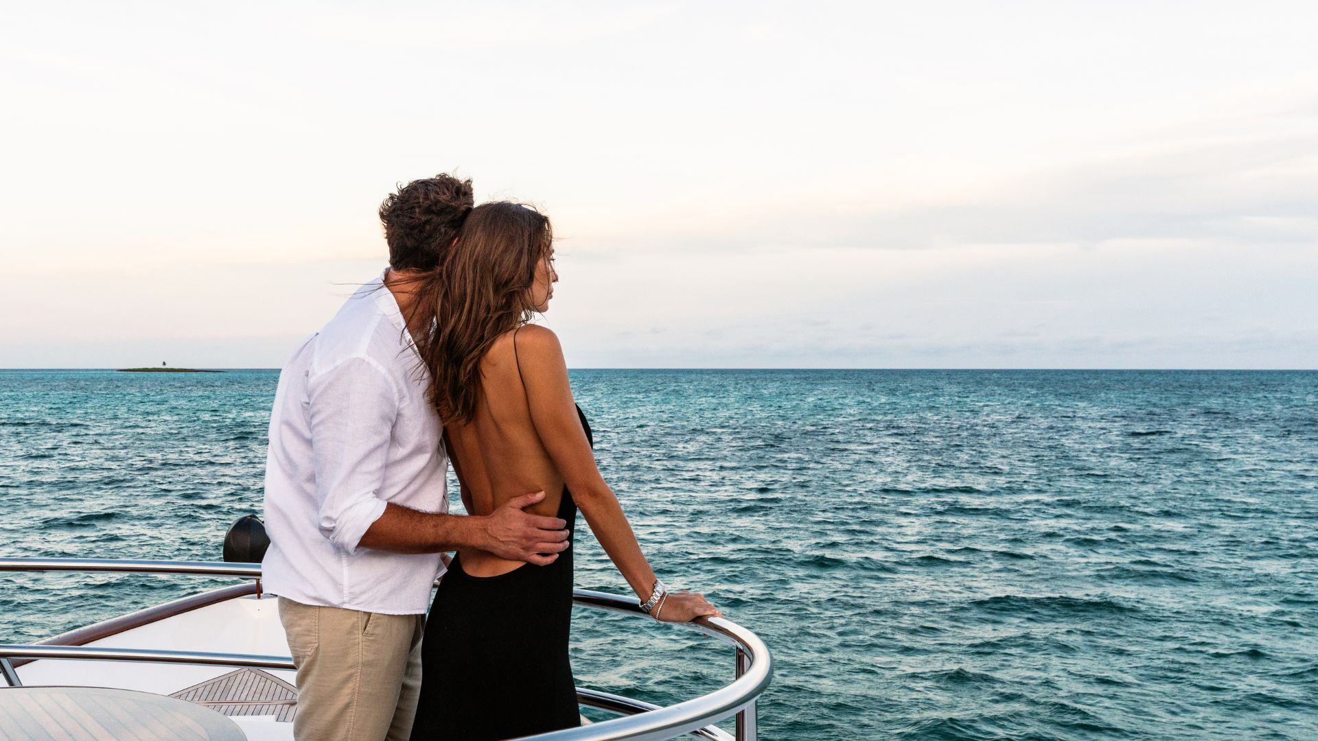 couple looking horizons onboard yacht