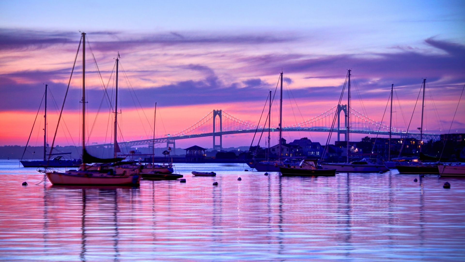 sailing yacht and jamestown bridge, rhode island during sunset