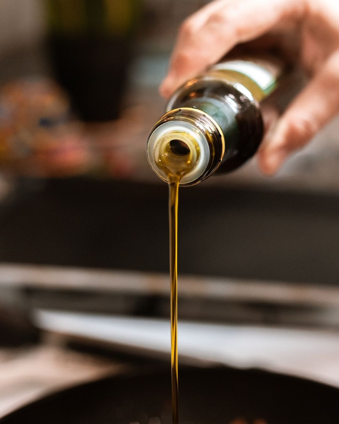 close up of pooring croatian olive oil in plate