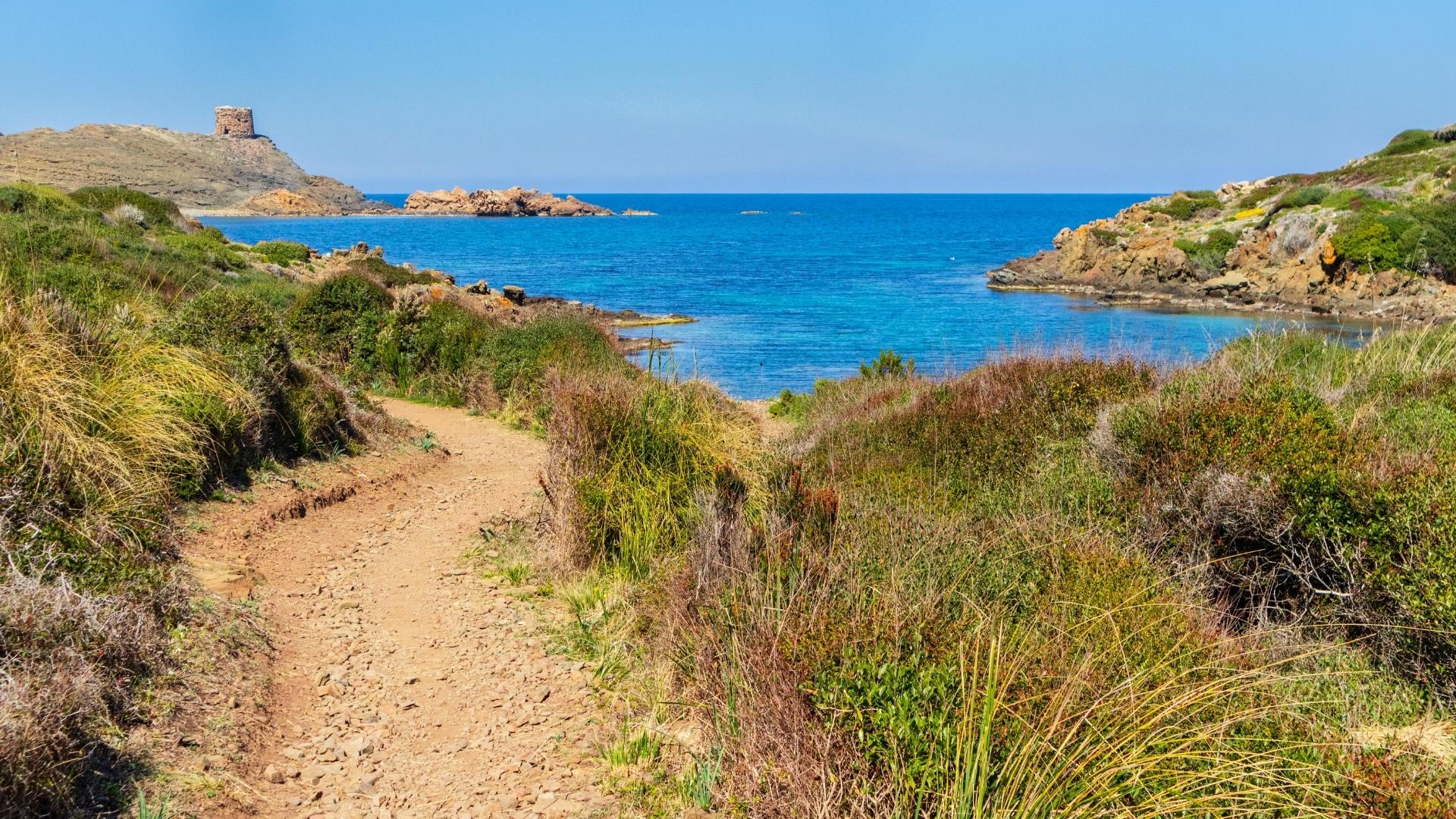 the cami de cavalls pathway in menorca spain with view of the beach