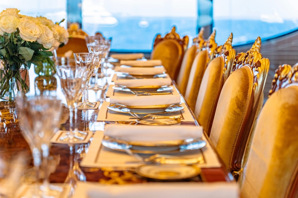 Large Groupclose up on the dining table of iyc sailing yacht black pearl