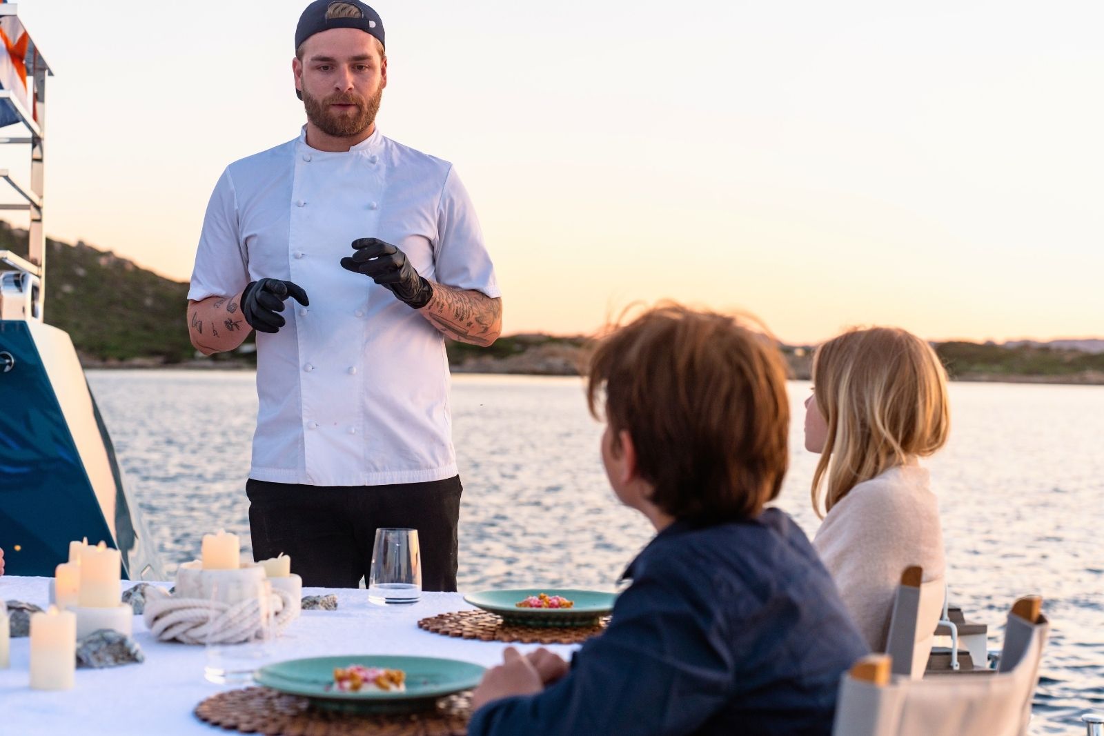 yacht chef speaking and teaching two children onboard