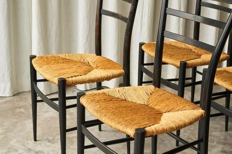 four black colored straw chiavari chairs