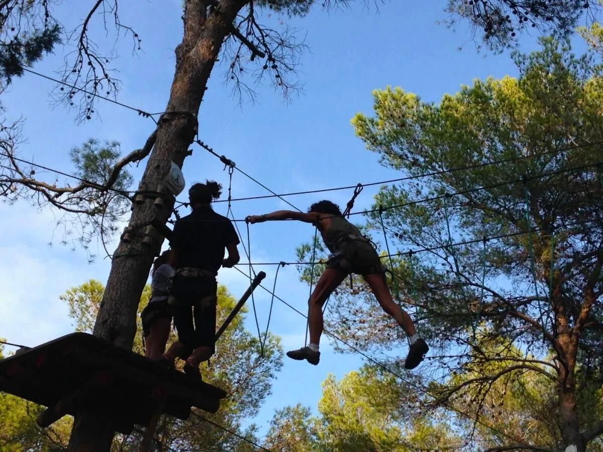two people in the acrobosc adventure park in ibiza