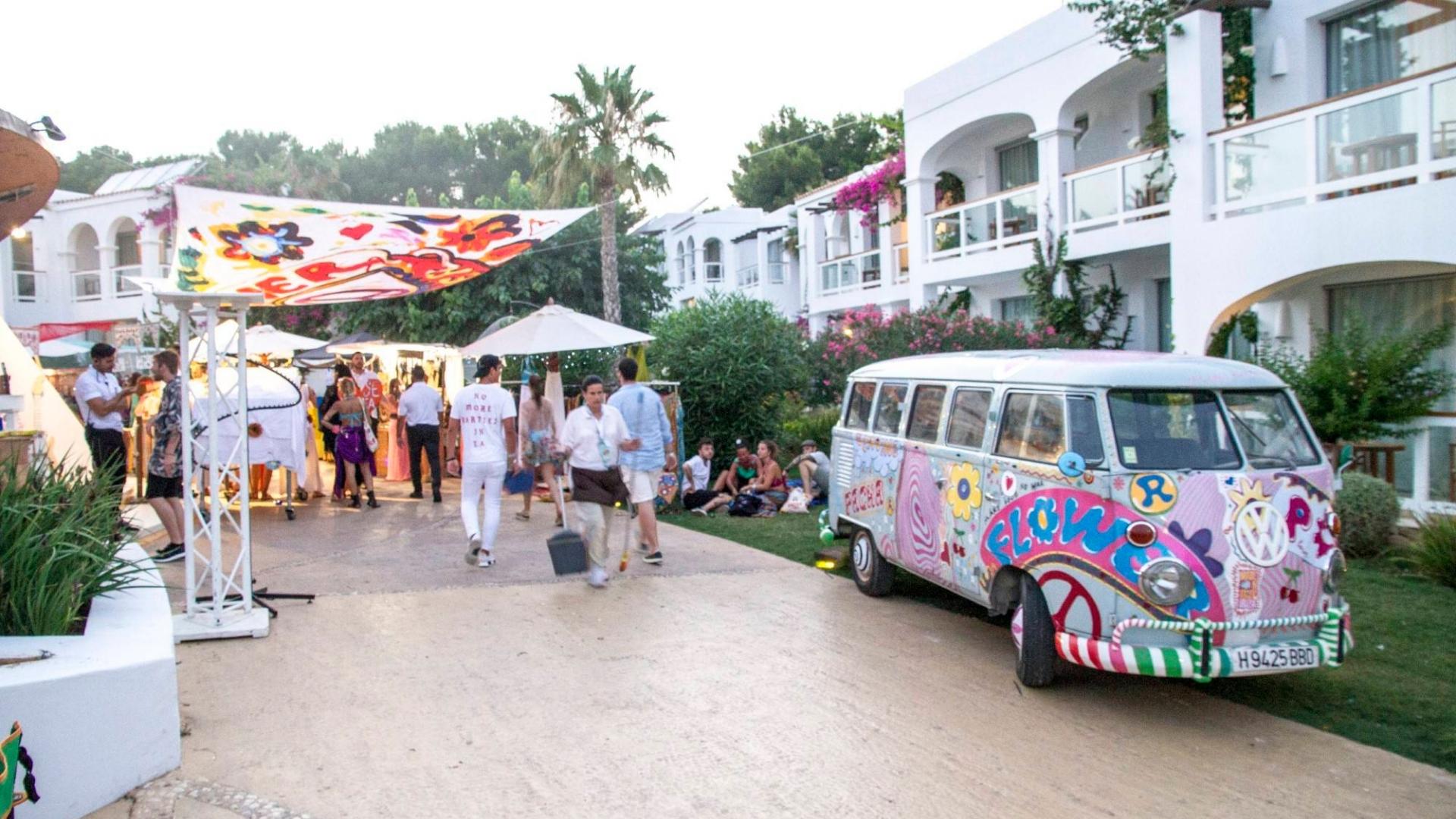 a painted van and people visiting las dalias market in ibiza
