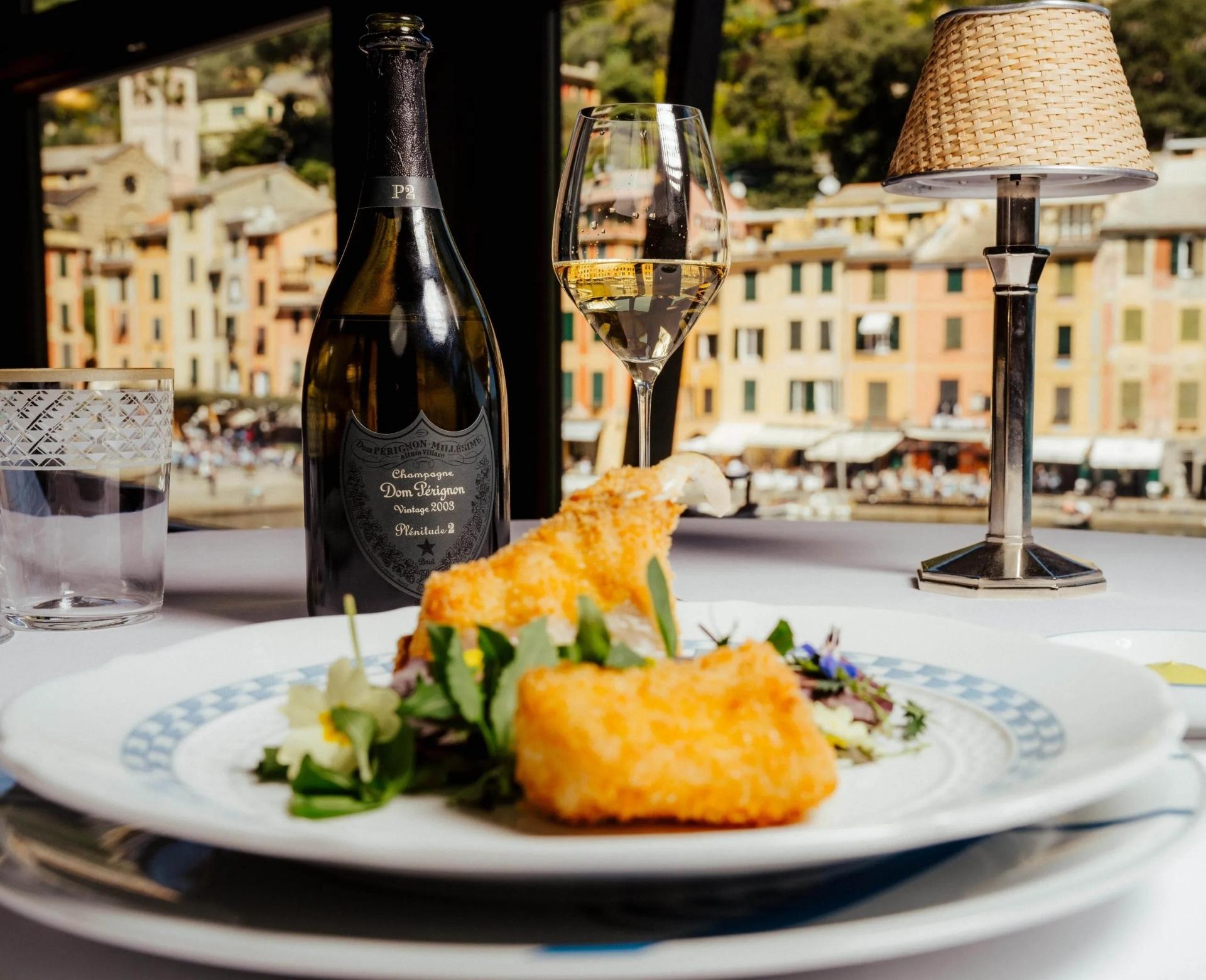 table view with seafood and wine with portofino on the background