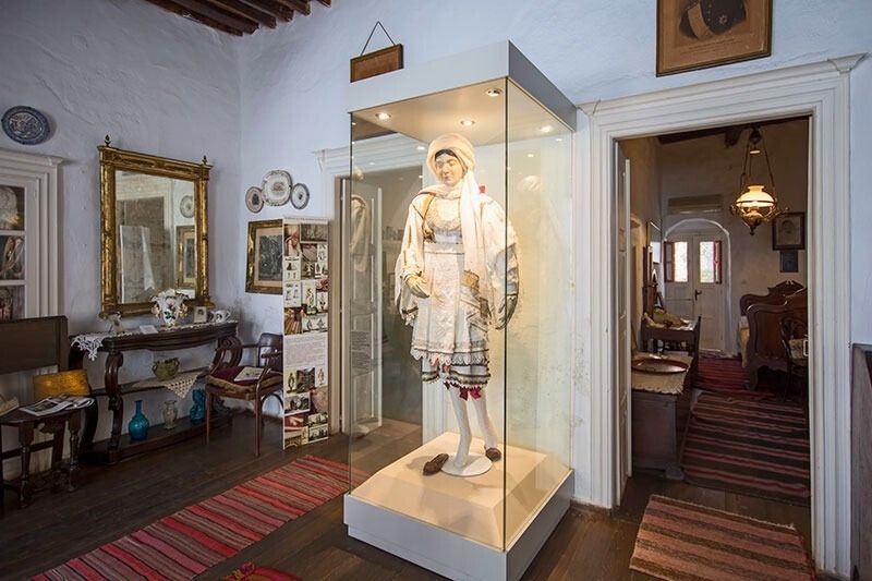 a traditional mykonian female attire on a display case at the folklore museum in mykonos greece