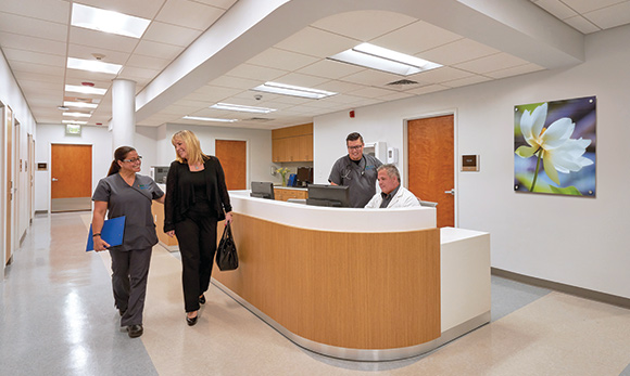 Staff and patient at UHealth Jackson Urgent Care in Keystone Point