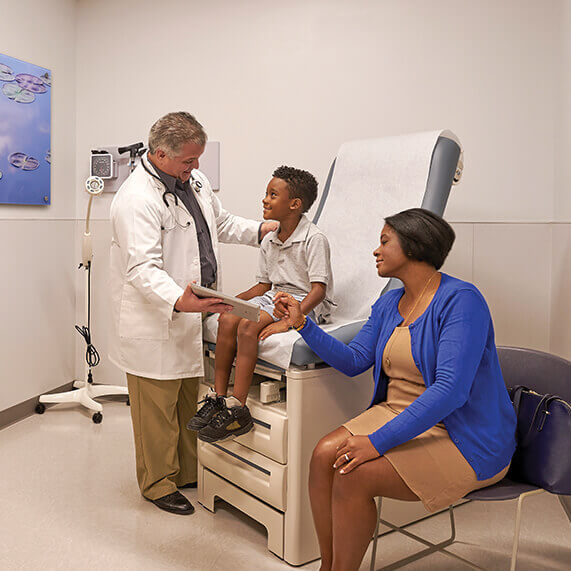 Mom and son being seen by a UHealth Jackson Urgent Care Doctor