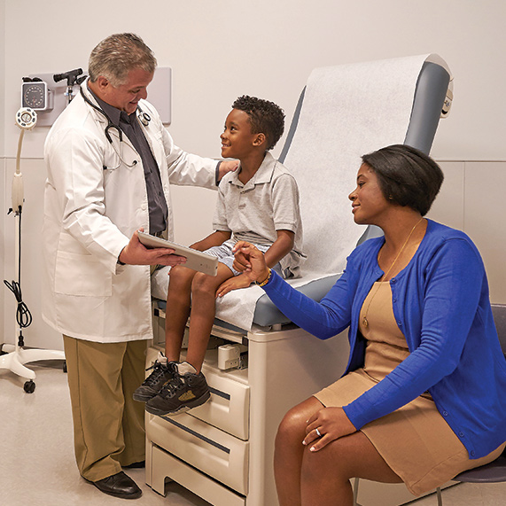 Mom and son being seen by a UHealth Jackson Urgent Care Doctor