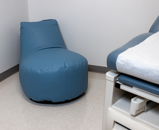 http://A%20blue%20bean%20bag%20chair%20in%20a%20medical%20room