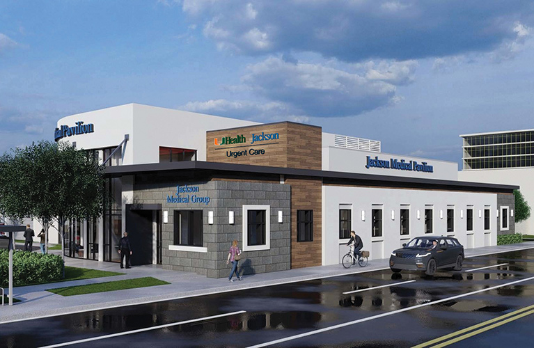An external image of a medical building, there are people outside and a car driving by