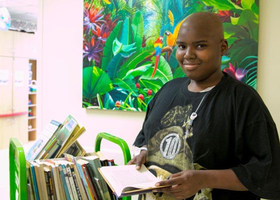 Emmanuel Cooper holding a book