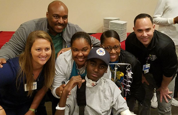 TJ with family and physicians