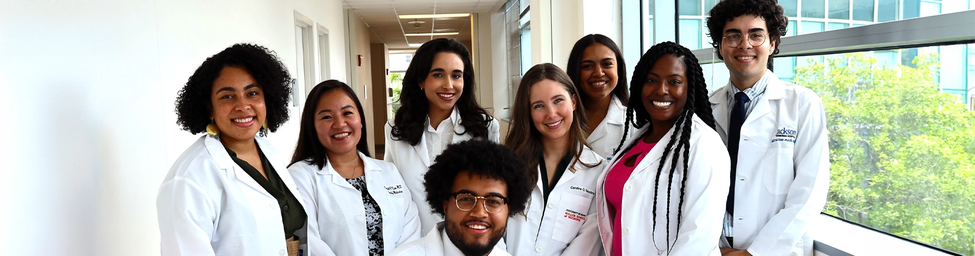 a group of medical colleagues posing and smiling at the camera