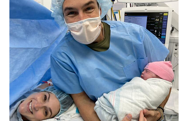 man next to his partner after giving birth