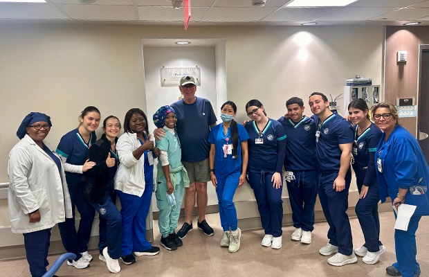 group of doctors and nurses posing for the camera