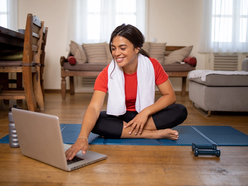 woman exercising at home in front of the computer