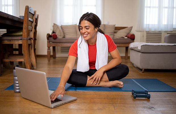 woman exercising at home in front of the computer