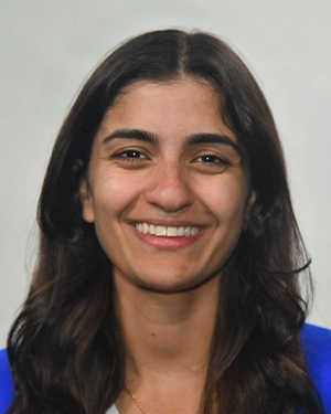 Close up of a girl with long black hair that is wearing a blue t-shirt