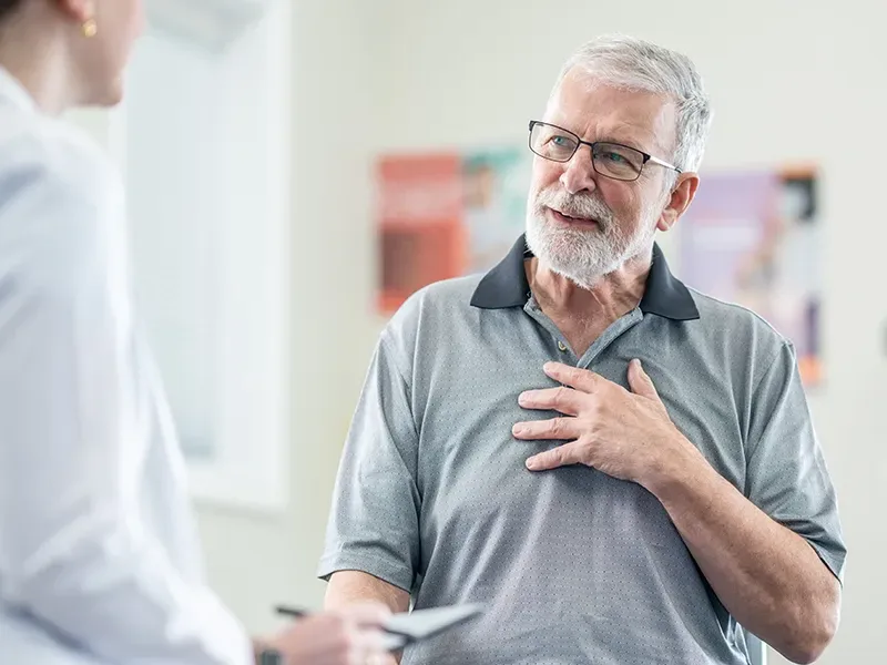 Senior citizen talking to a nurse in the hospital