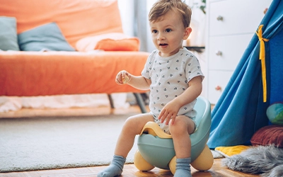 baby sitting on potty