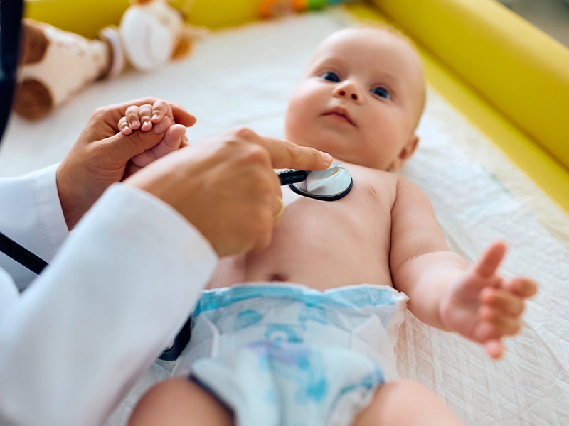 Baby being examined by a doctor with a stethoscope