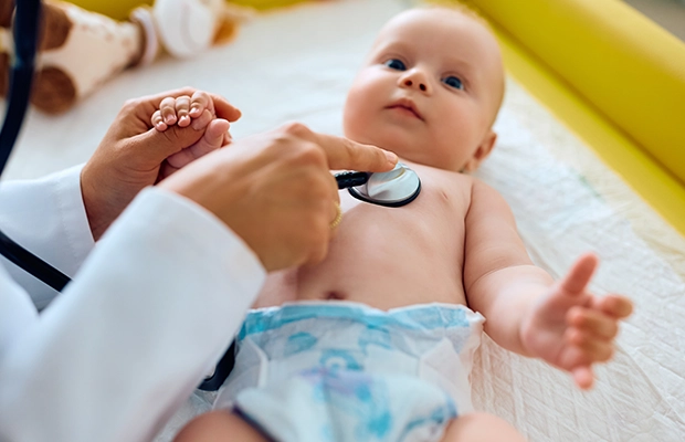 Baby being examined by a doctor with a stethoscope
